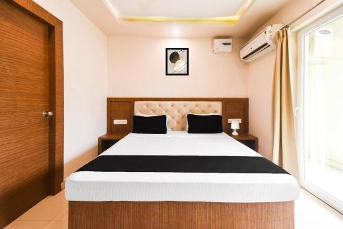 a bedroom with a bed and a window at Super Collection O Paschim Dwar Near Jagannatha Temple in Puri