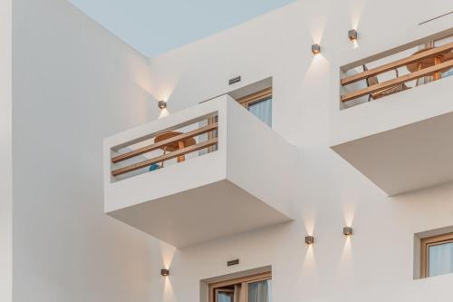 a staircase in a white building with windows at Aelo Mykonos Hotel in Paradise Beach