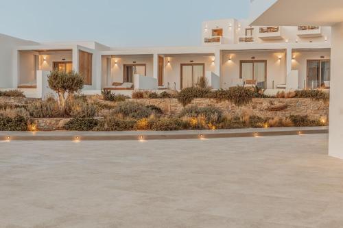 a white villa with a courtyard with lights at Aelo Mykonos Hotel in Paradise Beach