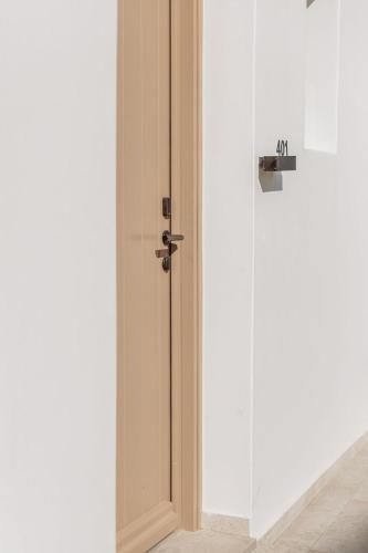 a glass door in a room with a wall at Aelo Mykonos Hotel in Paradise Beach