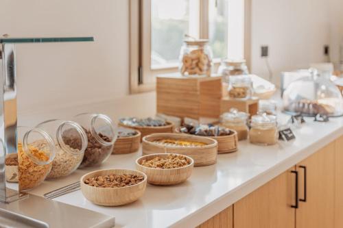 a kitchen counter with baskets of food on it at Aelo Mykonos Hotel in Paradise Beach