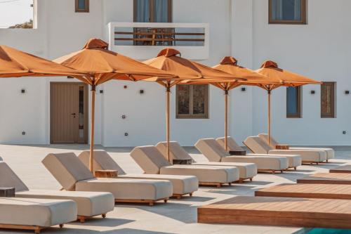 a row of chairs and umbrellas in a building at Aelo Mykonos Hotel in Paradise Beach