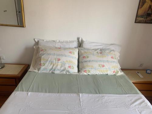 a bed with white sheets and pillows in a bedroom at SEAVIEW KAVALA PORT in Kavala