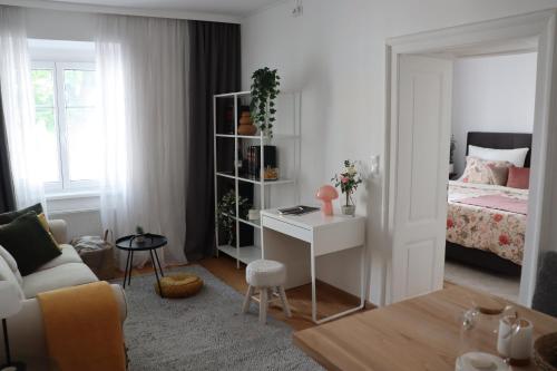 a bedroom with a bed and a desk in a room at City apartment with charm in Tulln