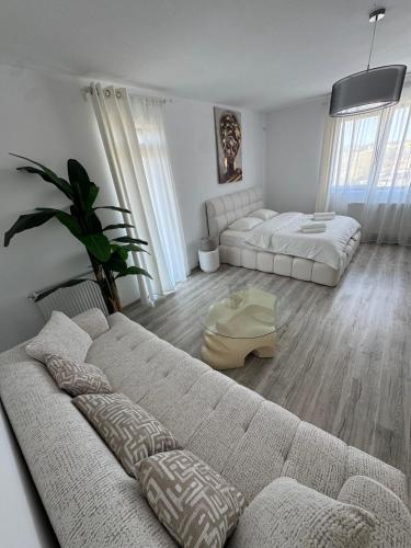 a living room with two beds and a couch at Daly Residence in Buzau