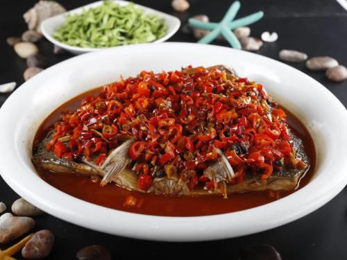 a white bowl of food with red rice and vegetables at Pullman Xiamen Powerlong in Xiamen