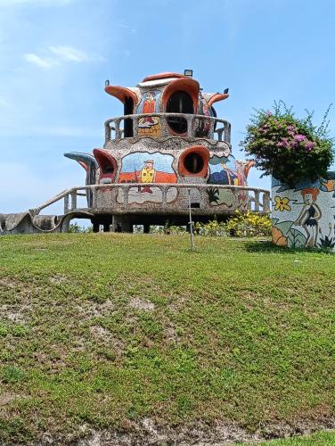 a building with graffiti on it in a field at Air Puteri Rest House in Mersing