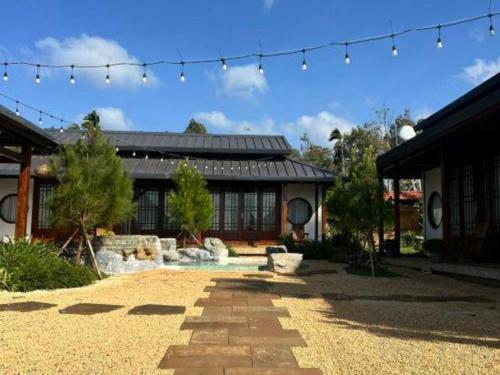 a house with a courtyard with a fountain and a building at Jun's Home in Buon Ma Thuot