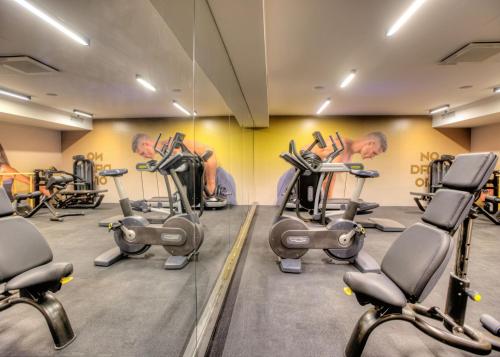 a room with a bunch of exercise bikes at Hotel Experience in Bečej