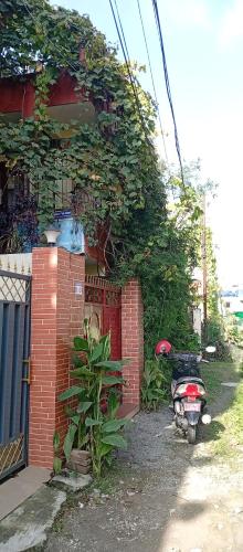 a motorcycle parked in front of a brick house at Everest Home Stay Apartment in Pātan