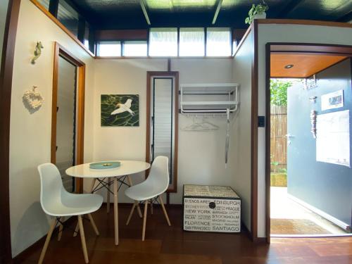 a small dining room with a table and chairs at Sleepy Hollow adorable peaceful guesthouse. in Gnarabup