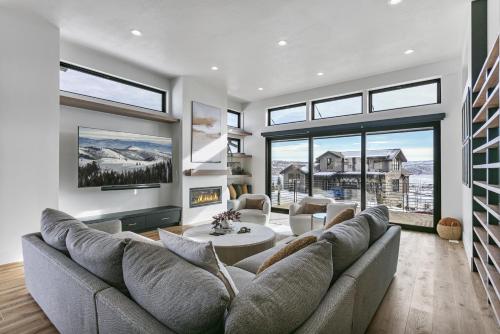 a living room with a couch and a table at 1506 W Orion Way - SkyRidge 6 BR Home with Hot Tub home in Keetley