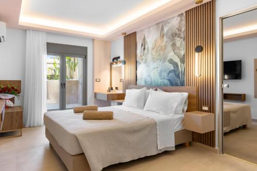 a bedroom with a large white bed and a bathroom at Casa De Sario in Rhodes Town