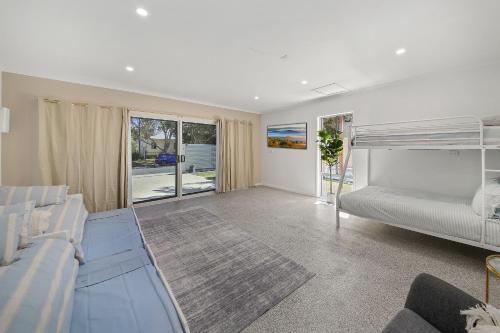 a living room with a bed and a couch at Golden Beach Oasis - Sleeps 12 in Golden Beach