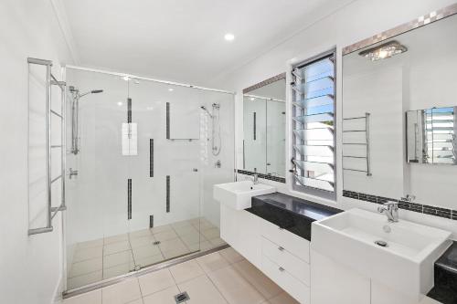 a white bathroom with a sink and a shower at Golden Beach Oasis - Sleeps 12 in Golden Beach