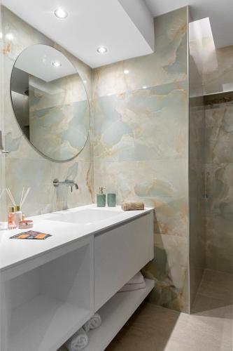a bathroom with a white sink and a mirror at Casa De Sario in Rhodes Town