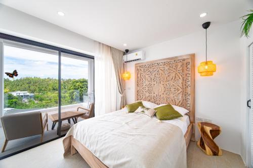 a bedroom with a bed and a large window at 2BR Emerald Villa Private Pool & Sea View B30-1 in Amphoe Koh Samui