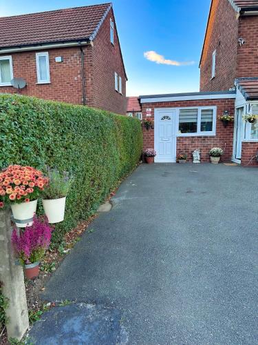 a driveway in front of a house with a garage at Studio Flat in Wythenshawe