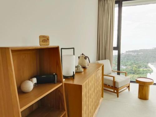 a hotel room with a desk and a chair and a window at Anzhu Seamate Villa Samui in Amphoe Koh Samui