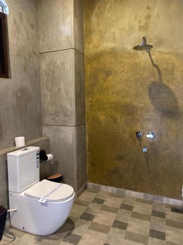 a bathroom with a toilet and a shower at Negombo Boutique Villa in Negombo