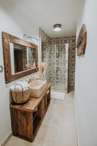 a bathroom with a sink and a mirror at Villa Serena in Siklós
