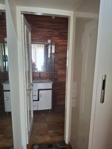 a kitchen with a sink and a mirror at Sunrise Villa in Kharar