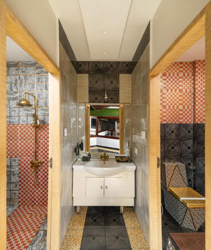 a bathroom with a white sink and a shower at Parakkat Nature Resort in Munnar