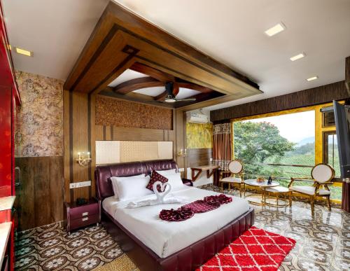 a bedroom with a bed and a table and chairs at Parakkat Nature Resort in Munnar