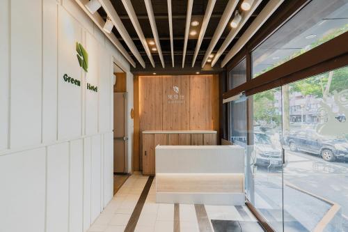 a lobby of a store with a bench and a door at Green Hotel - Fengjia in Taichung