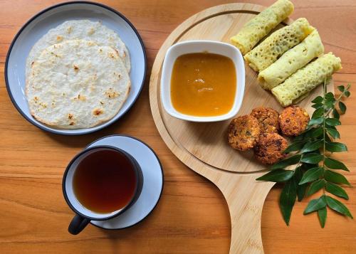 a table with a plate of food and a cup of tea at Safaria Lodge Wilpattu in Pahala Maragahawewa