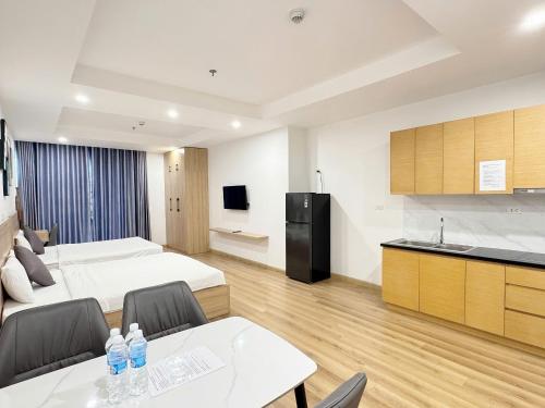 a hotel room with a bed and a kitchen at Seafront Apartment TMS Quy Nhơn in Quy Nhon