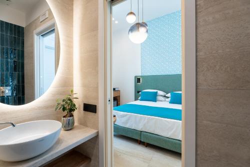 a bathroom with a bed and a sink and a mirror at Domus Gualtieri in Sorrento