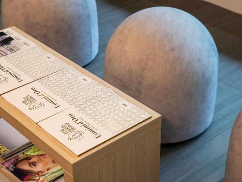 a wooden box with a sign next to two balls at Mercure Milano Agrate Brianza in Agrate Brianza