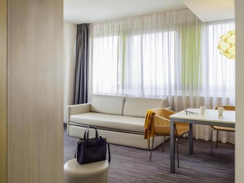 a living room with a couch and a table at Mercure Milano Agrate Brianza in Agrate Brianza