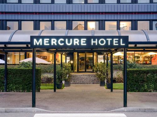 a sign for a hotel in front of a building at Mercure Milano Agrate Brianza in Agrate Brianza