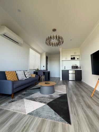 a living room with a couch and a table at Paradise Retreat in Tauranga