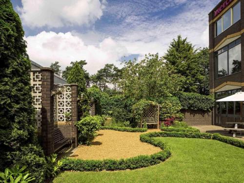 a garden with a gravel path in front of a building at Mercure Norwich Hotel in Norwich