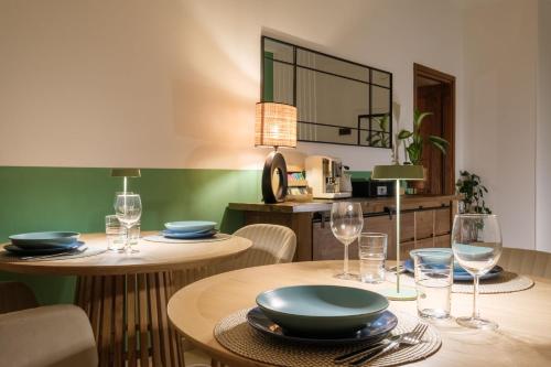 a dining room with two tables with wine glasses at Casita de Luna- Affittacamere Bologna in Bologna
