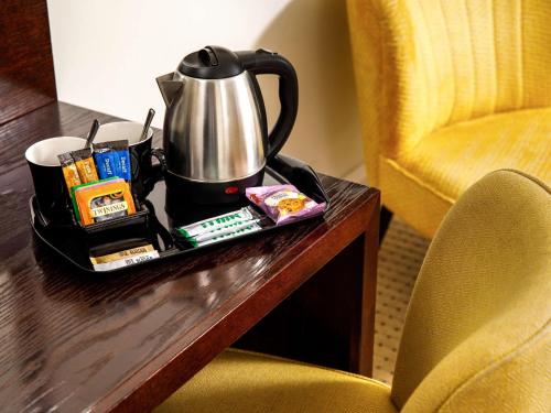a tea kettle on a tray on a table at Mercure Gloucester Bowden Hall Hotel in Gloucester