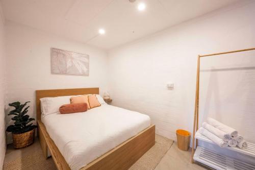 a small bedroom with a bed and a shower at Garden Apartment in the heart of Bondi in Sydney
