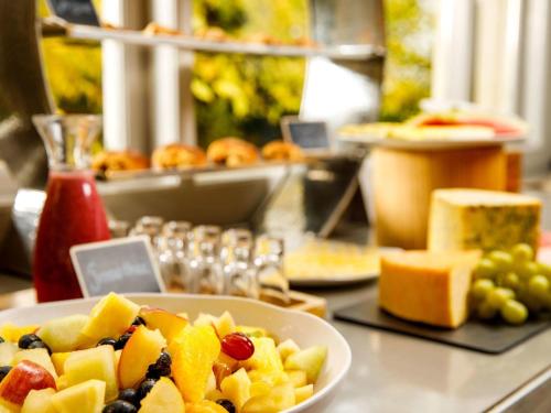 a table with a plate of fruit on a counter at Mercure Bristol North The Grange Hotel in Bristol