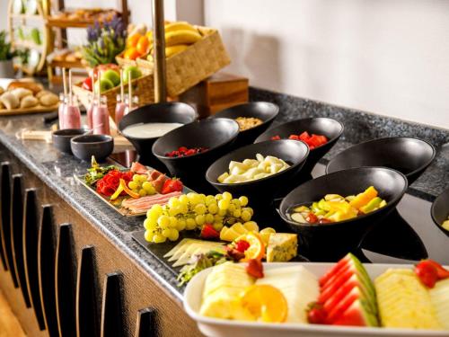 a buffet filled with different types of food on a table at Mercure Bolton Georgian House Hotel in Bolton