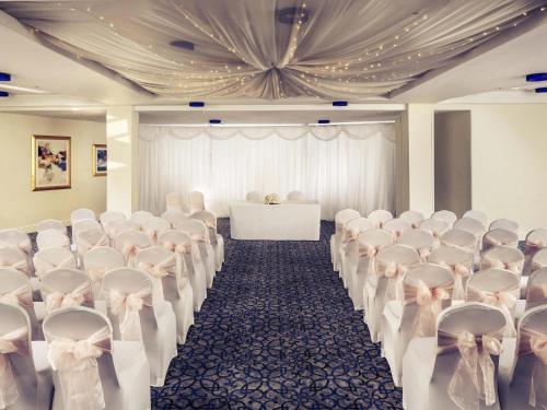 a room with rows of chairs and a table at Mercure Bolton Georgian House Hotel in Bolton