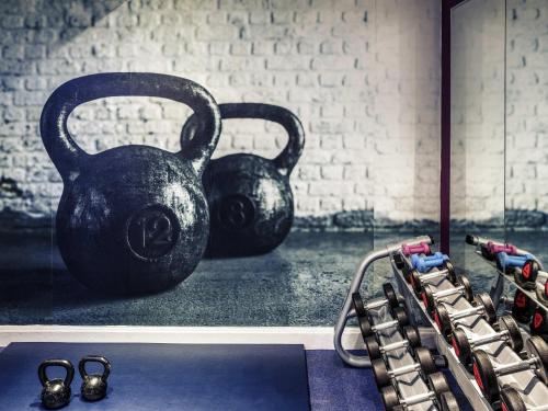 a gym with a black kettlebell and a row of shoes at Mercure Chester Abbots Well Hotel in Chester