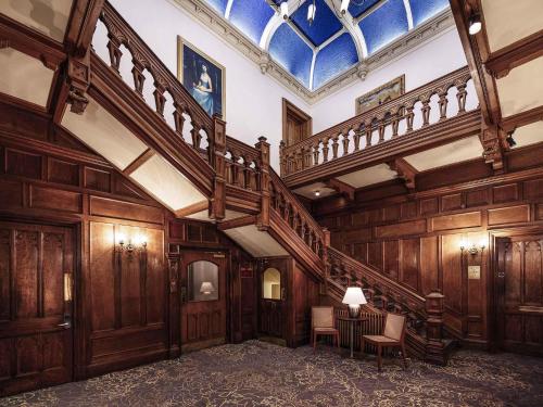 a large room with wooden walls and a spiral staircase at Mercure Bradford, Bankfield Hotel in Bradford
