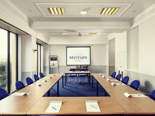 a meeting room with a long table and chairs at Mercure Bradford, Bankfield Hotel in Bradford