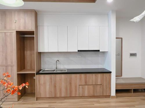 a kitchen with white cabinets and a sink at Seafront Apartment TMS Quy Nhơn in Quy Nhon