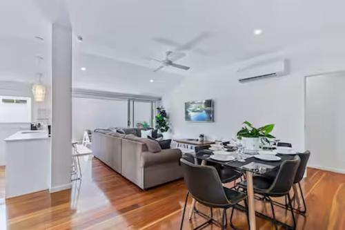 a living room with a table and a couch at Park Avenue Terrace 1BR, 4km to CBD, WiFi, Park in Brisbane