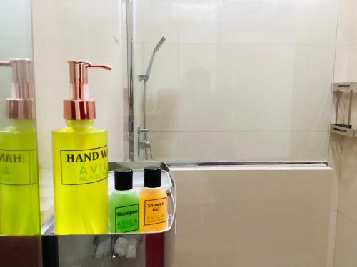 a bathroom with two bottles of hand sanitizer on a counter at Avila Nilaveli Beach in Nilaveli