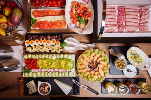 a table topped with lots of different types of food at Villa Bellevue Portoroz-Portorose in Portorož